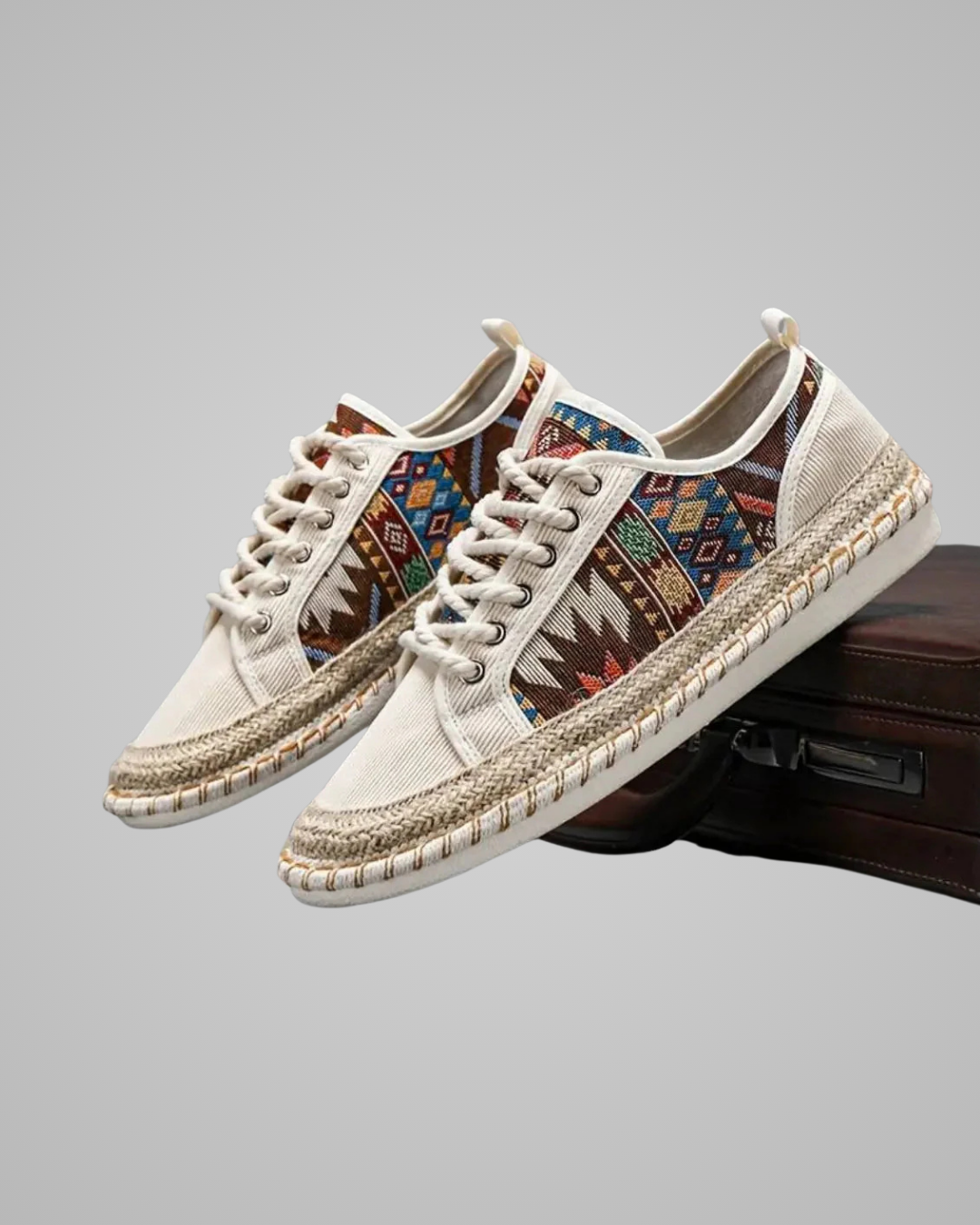 Pair of white sneakers with colorful pattern on a gray background