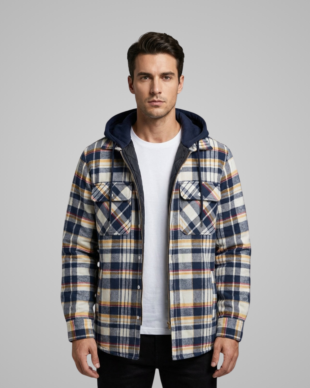 Man wearing a plaid jacket with a hood on a gray background