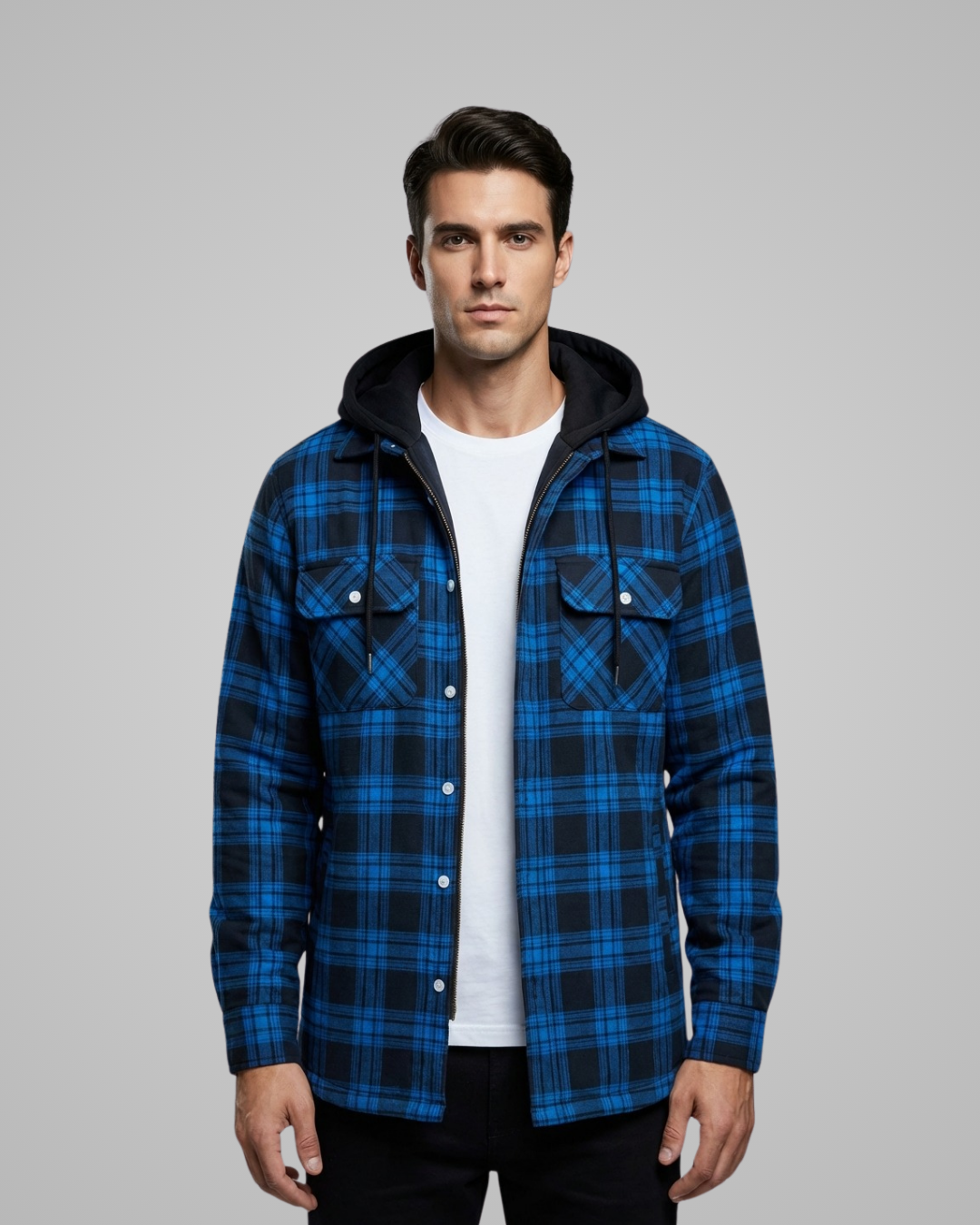 Man wearing a blue plaid jacket with a black hood on a gray background