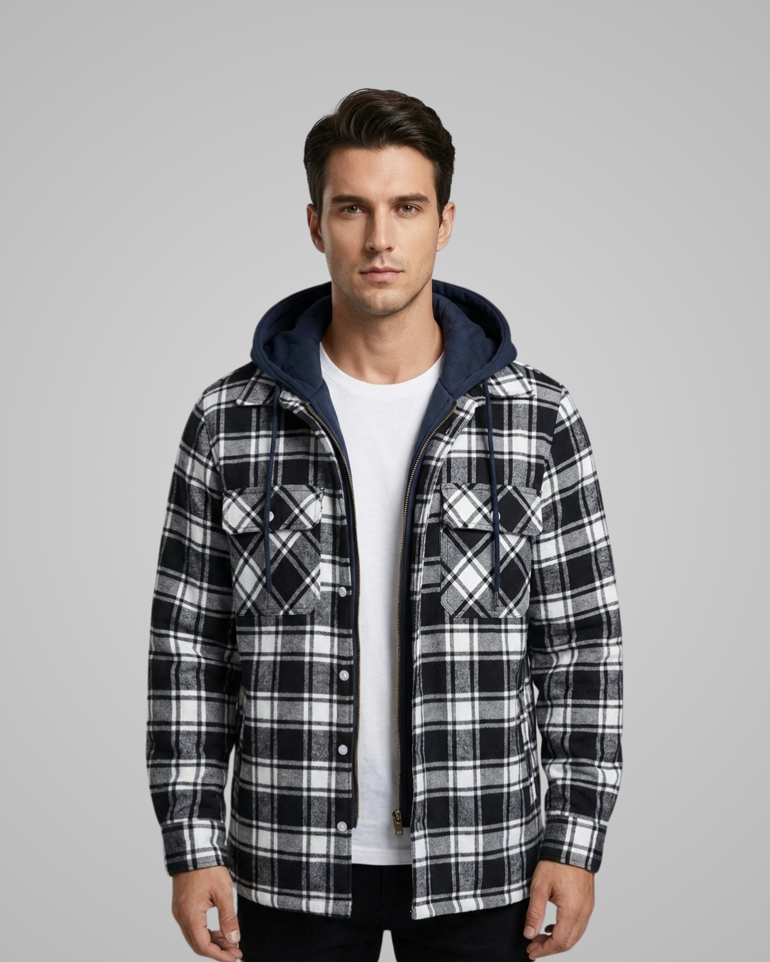 Man wearing a black and white plaid jacket with a hood on a gray background