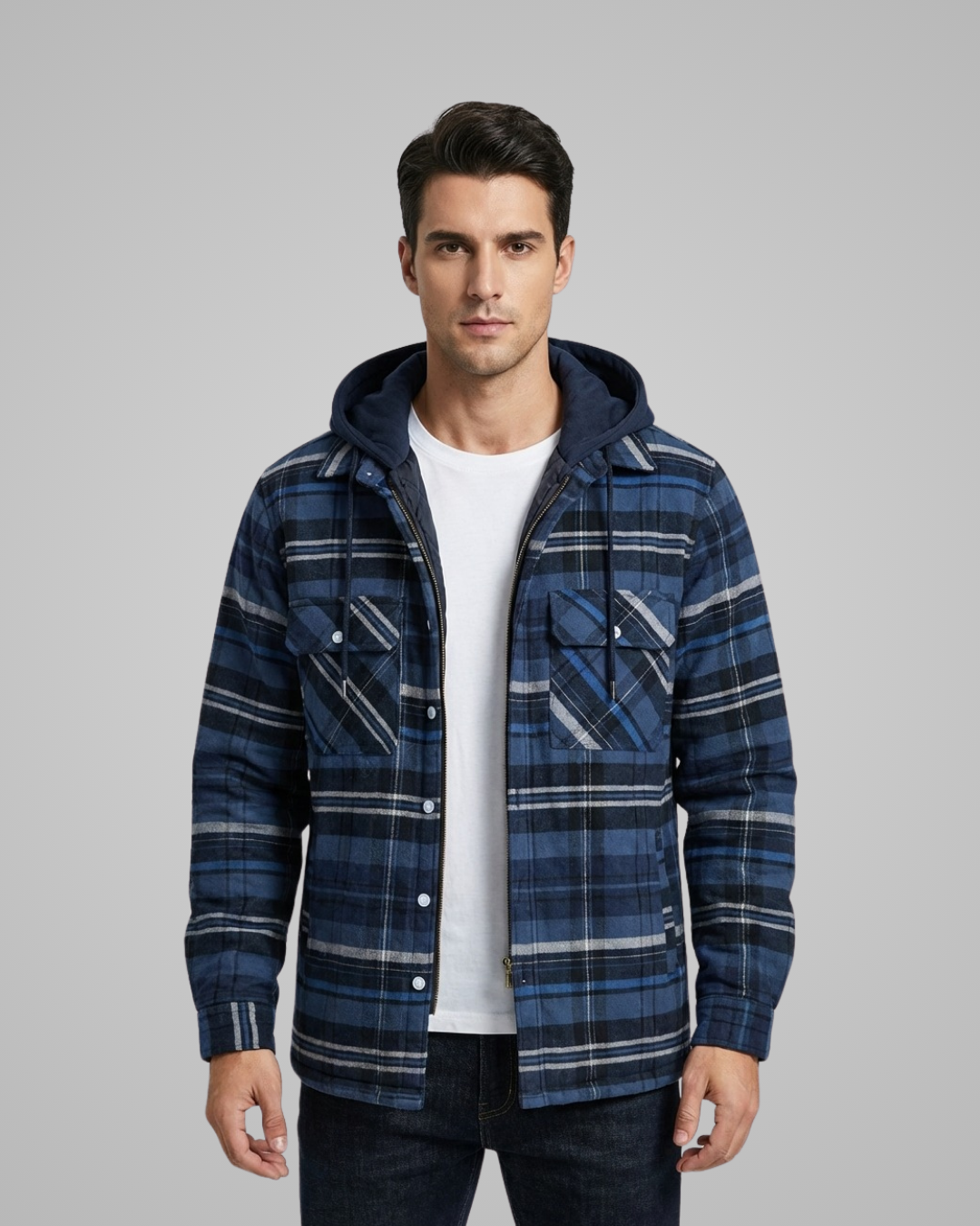 Man wearing a blue plaid jacket with a hood on a gray background