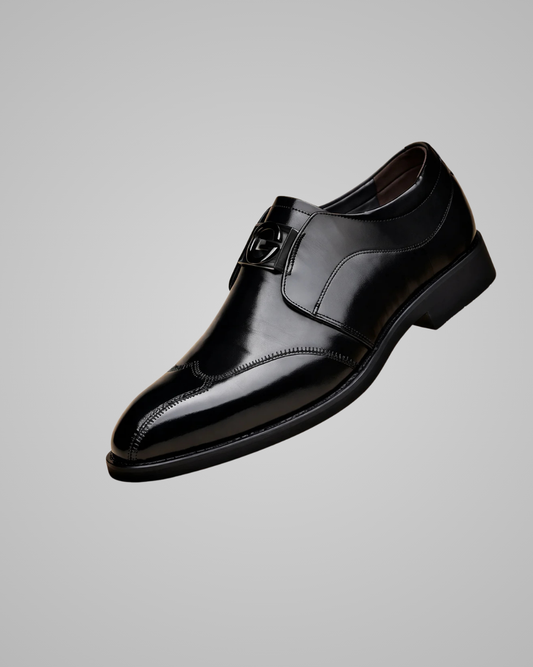 Black dress shoe on a gray background