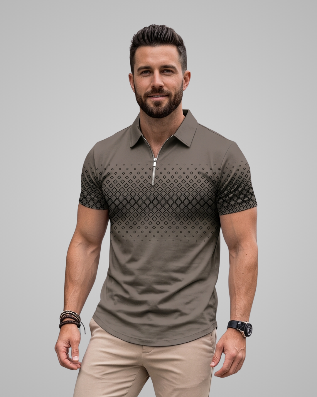 A man wearing a short-sleeve polo shirt with a half-zip collar and a geometric pattern on the upper chest and sleeves, paired with beige pants, against a solid gray background.
