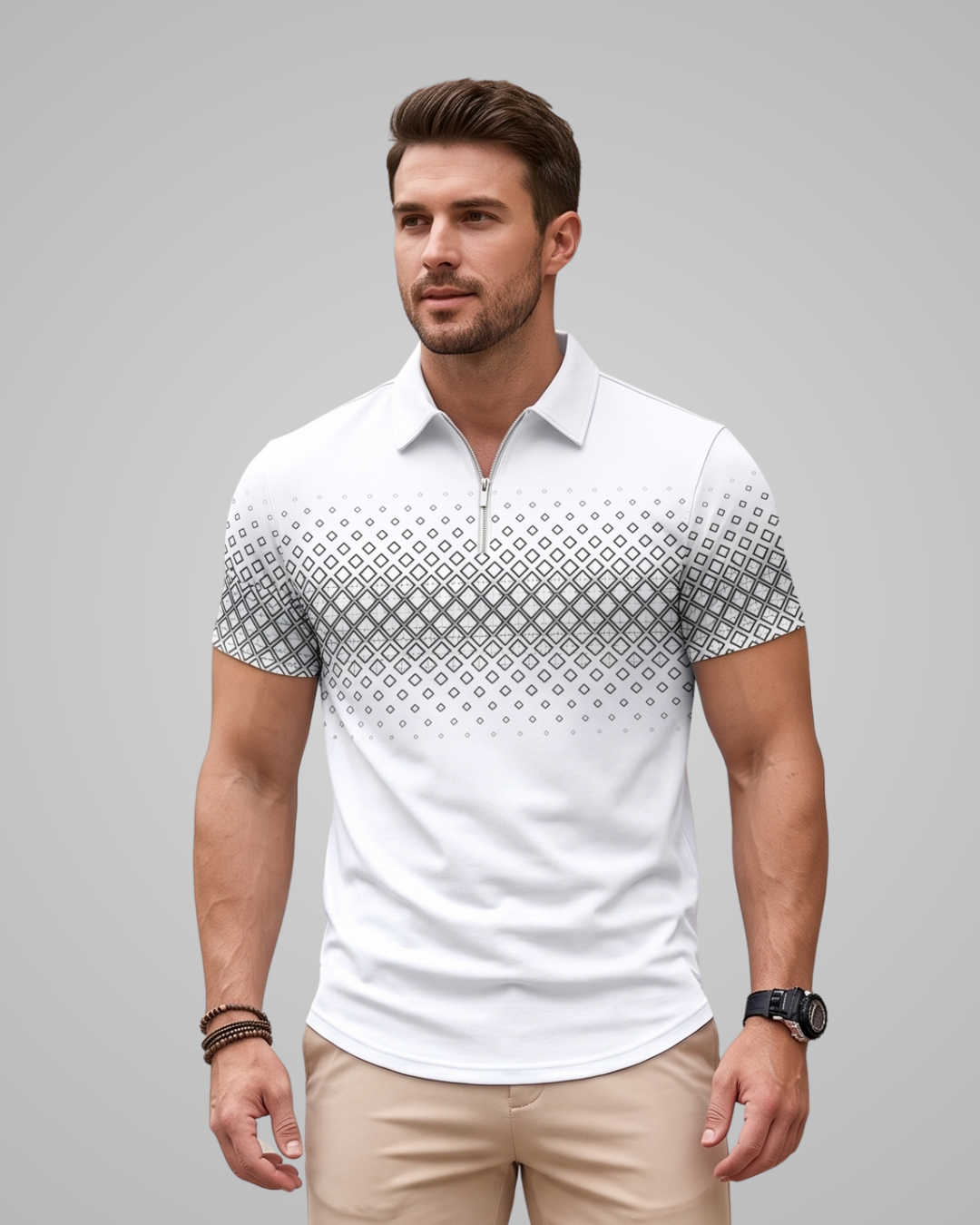 A man wearing a white short-sleeve polo shirt with a gray geometric diamond pattern across the chest and shoulders, paired with beige pants, against a solid gray background.