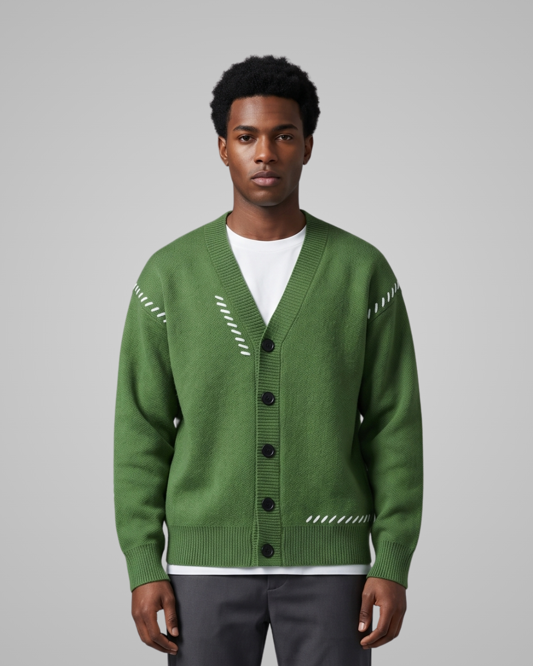 Man wearing a green cardigan with white patterns on a gray background