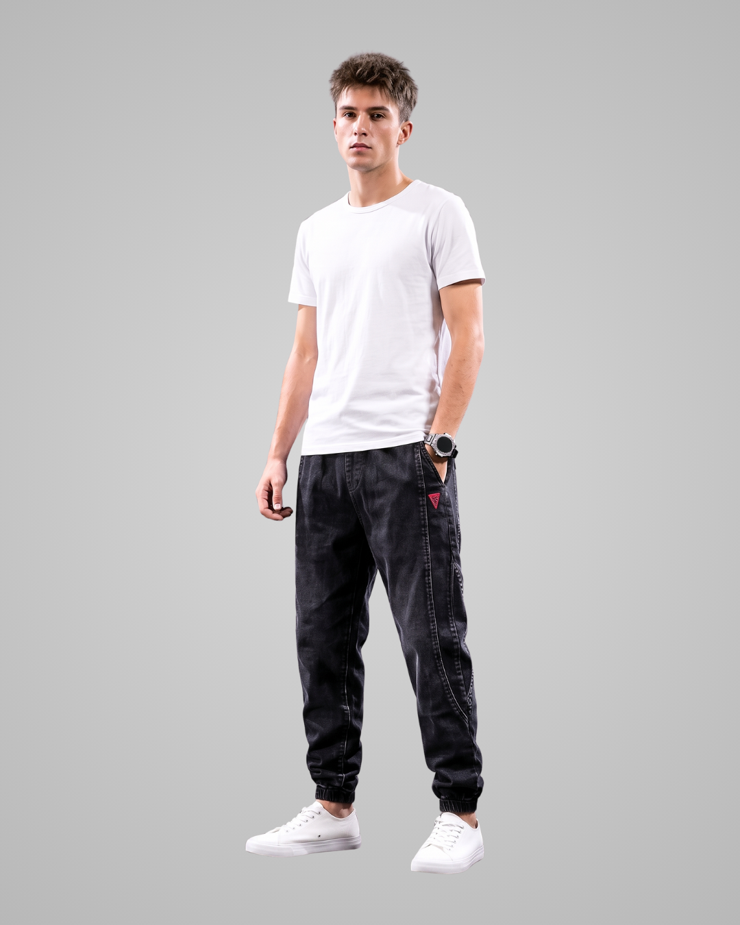 Person wearing a white t-shirt and black jogger pants on a gray background