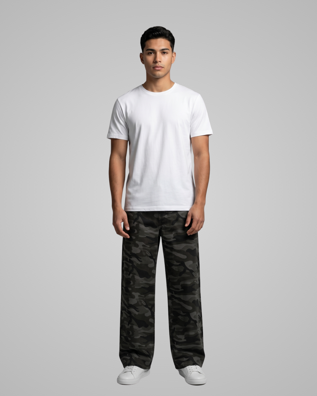 Person wearing a white t-shirt and camouflage pants on a gray background