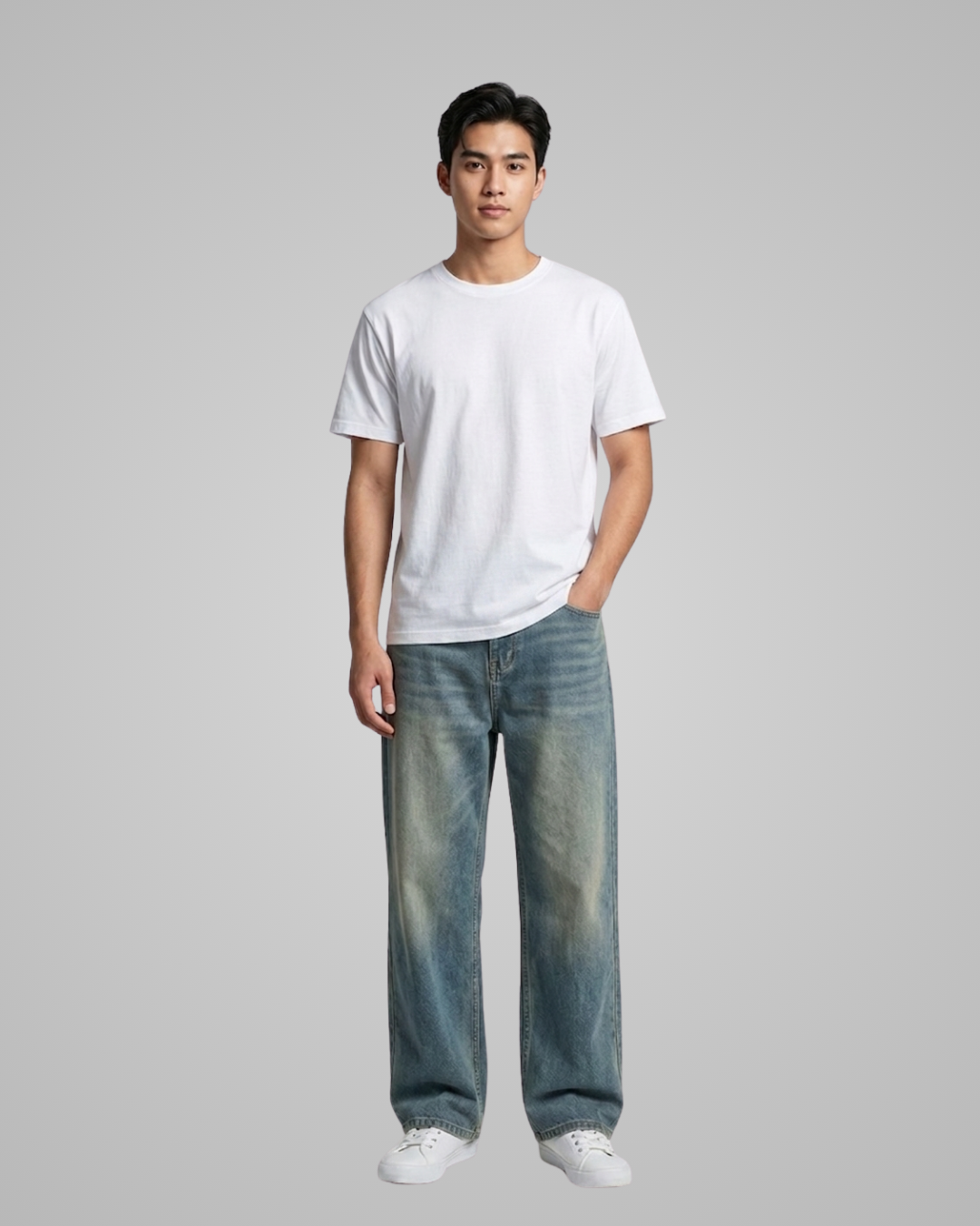 Person wearing a white t-shirt and blue jeans on a gray background