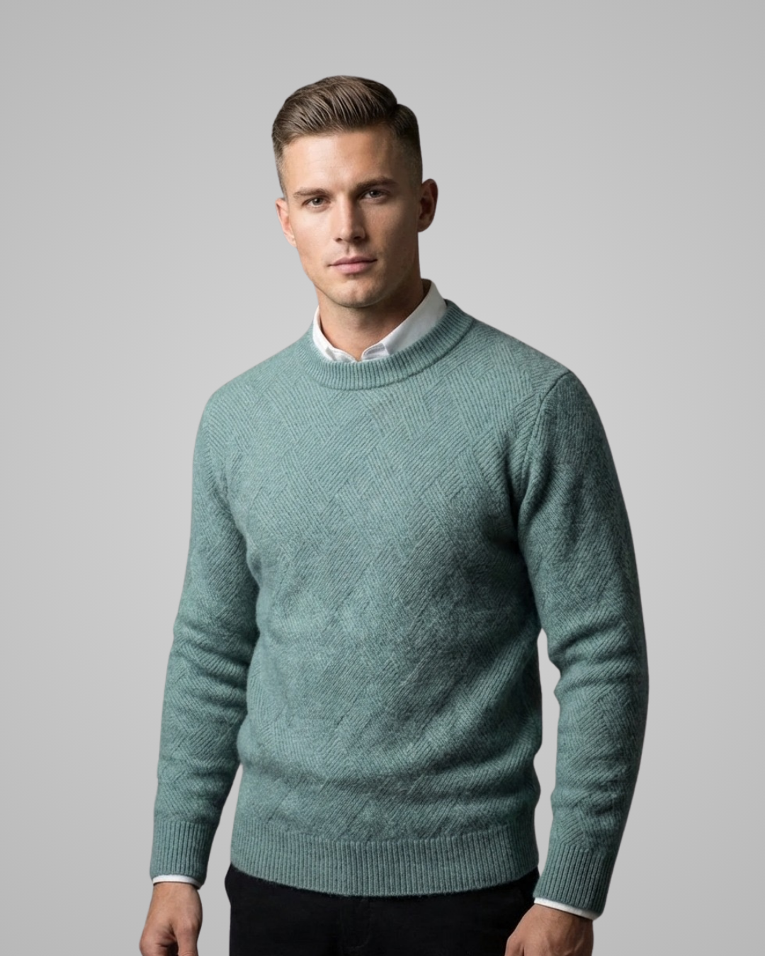 Man wearing a teal sweater against a plain background