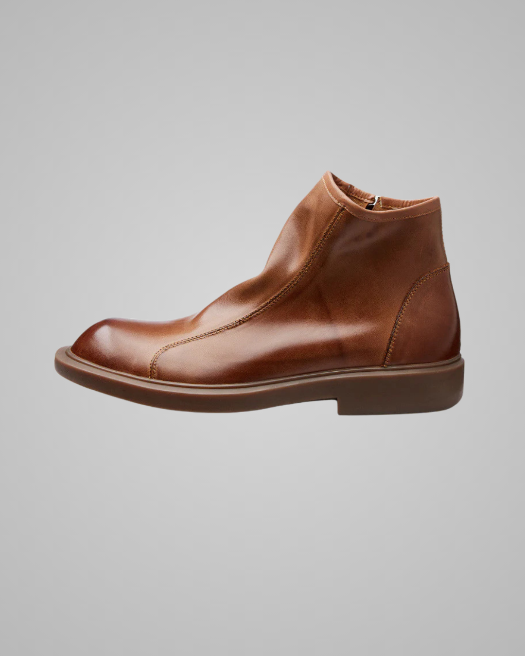 Brown leather ankle boot on a gray background