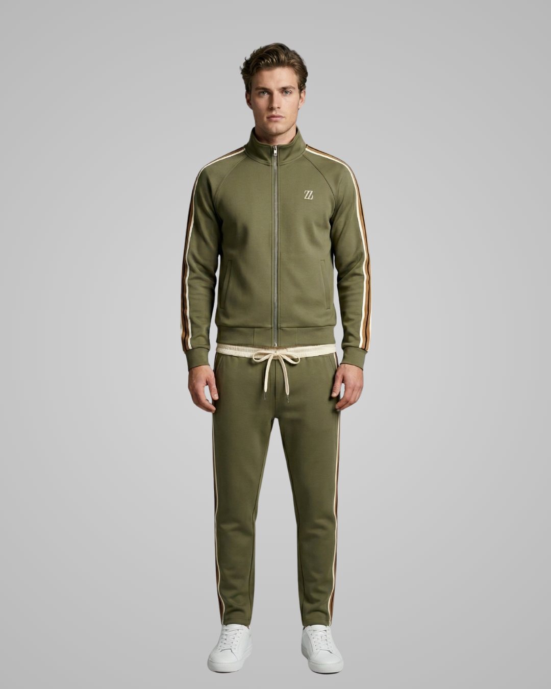 Man wearing a green tracksuit with white stripes on a gray background