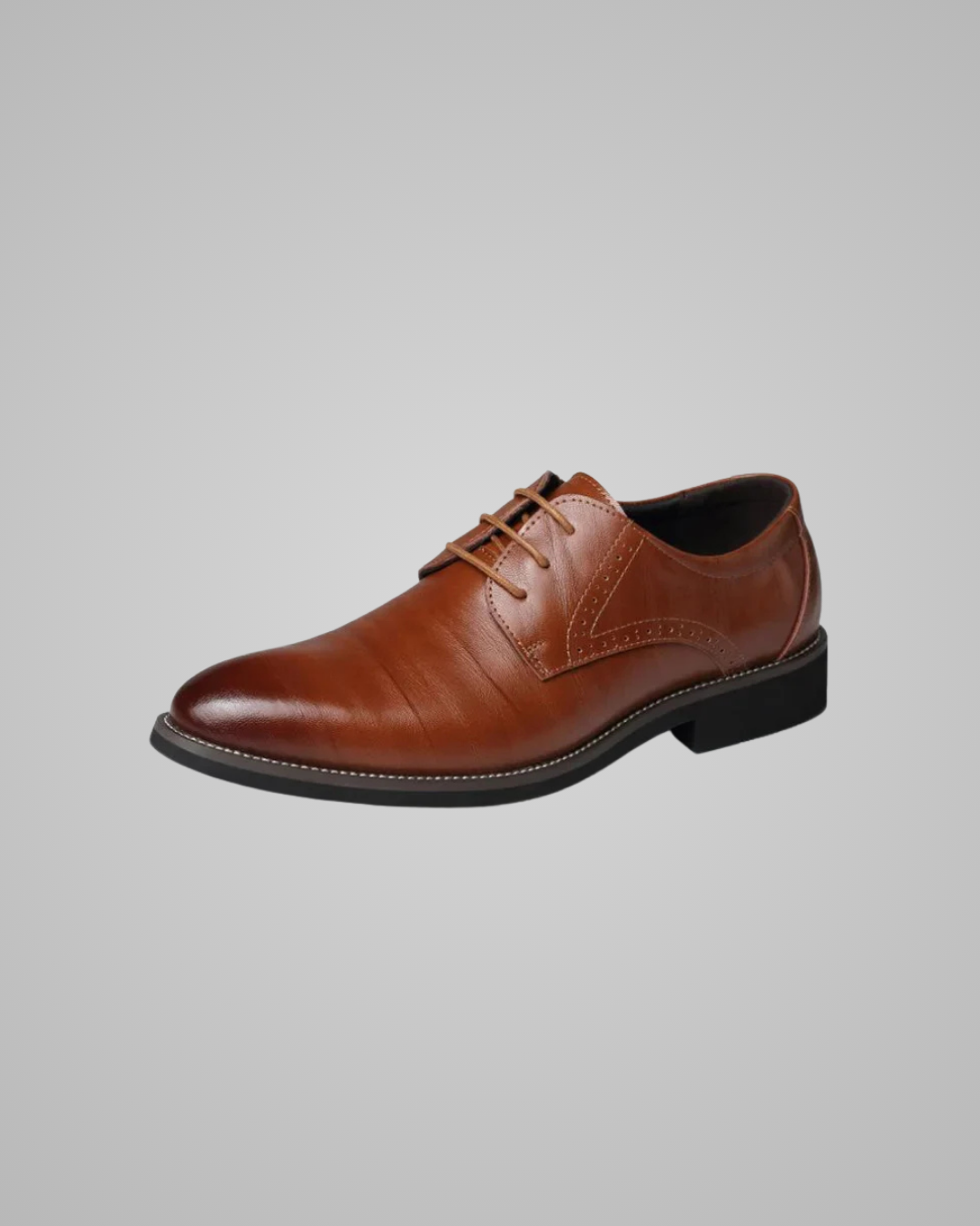 Brown leather dress shoe on a gray background