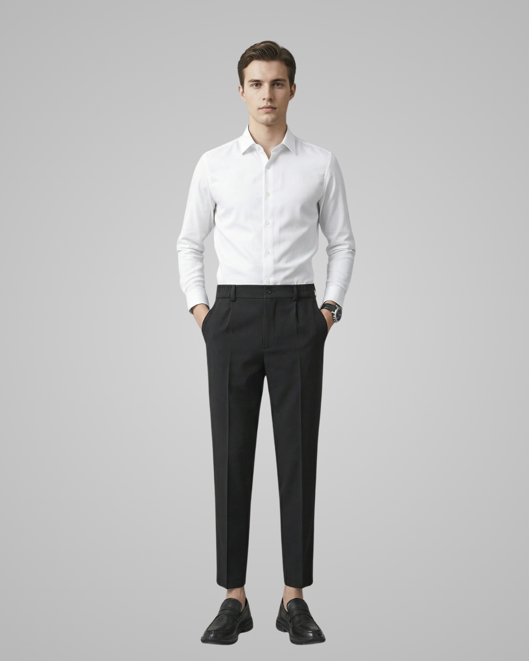 Man wearing a white dress shirt and black pants on a gray background