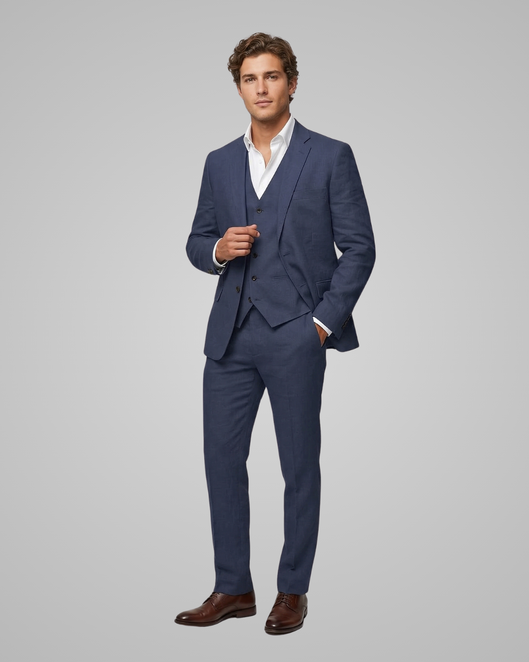 Man wearing a blue suit with a white shirt on a gray background