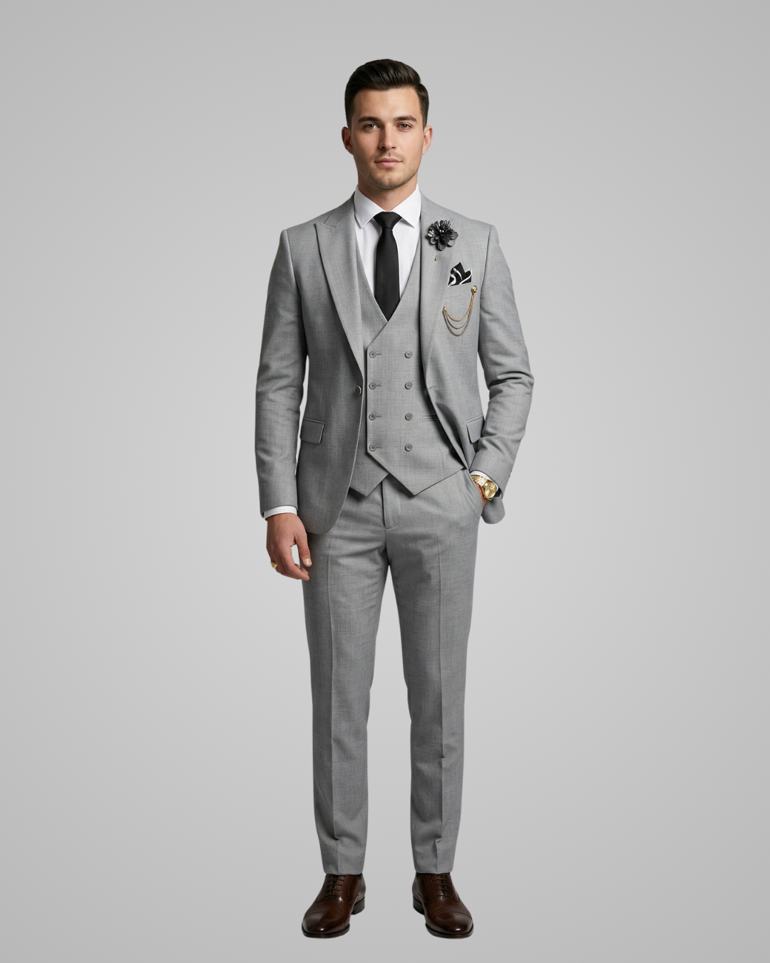 Man wearing a gray suit with a white shirt, black tie, and brown shoes on a gray background