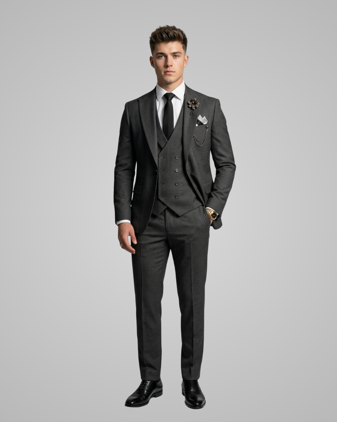 Man wearing a gray suit with a white shirt and black tie on a gray background