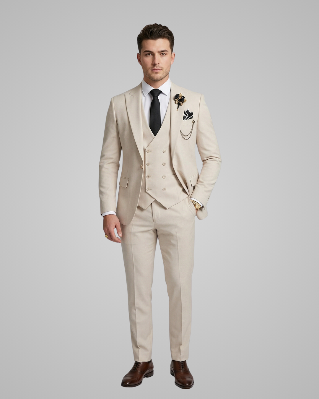 Man wearing a beige suit with a white shirt and black tie on a gray background