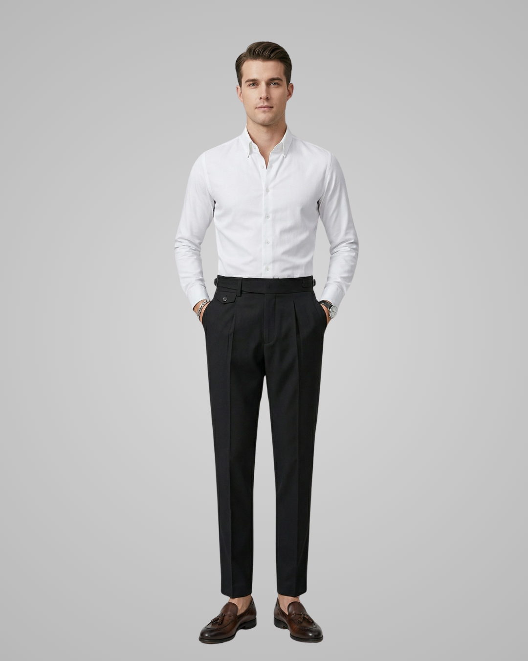 Man wearing a white dress shirt and black pants on a gray background