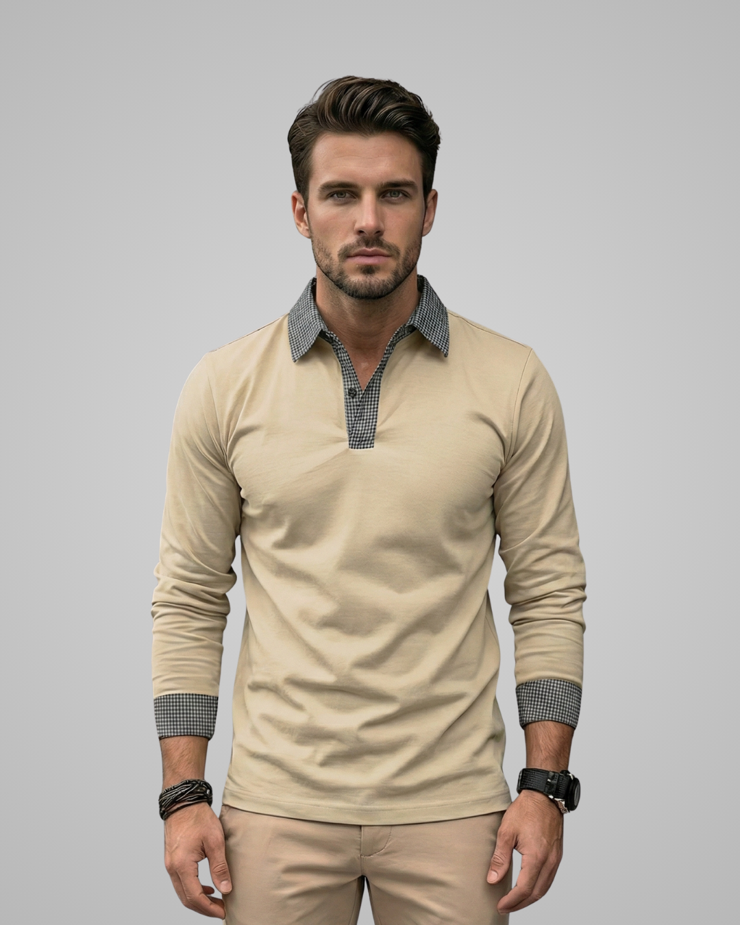 Man wearing a beige long-sleeve shirt with patterned cuffs and collar against a gray background