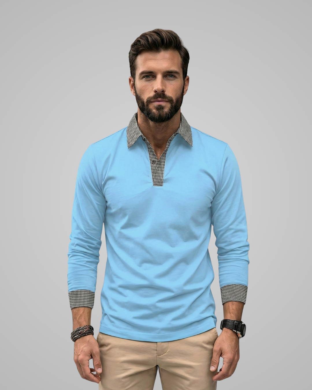 Man wearing a light blue long-sleeve shirt with patterned cuffs on a gray background