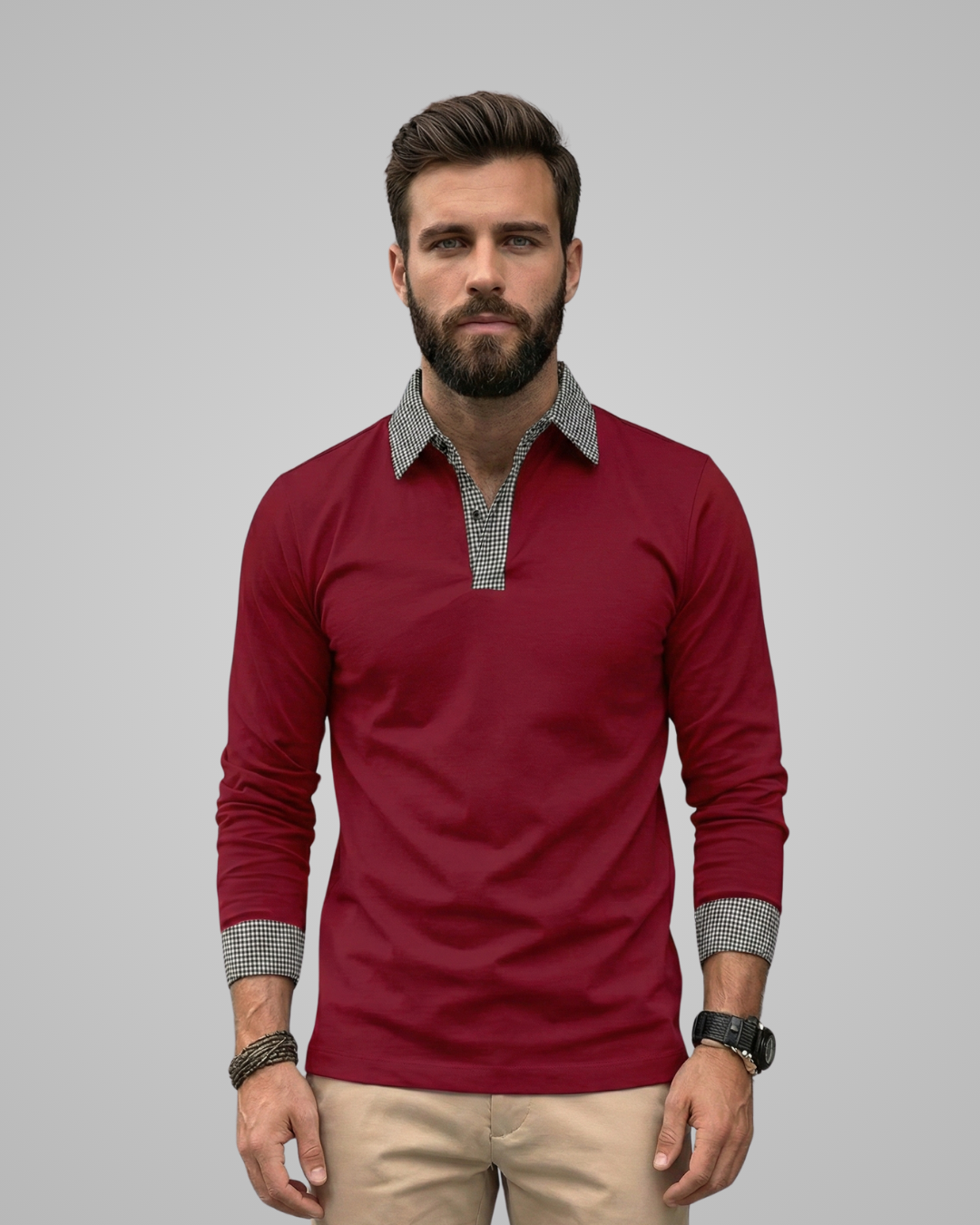 Man wearing a red long-sleeve shirt with a checkered collar against a gray background