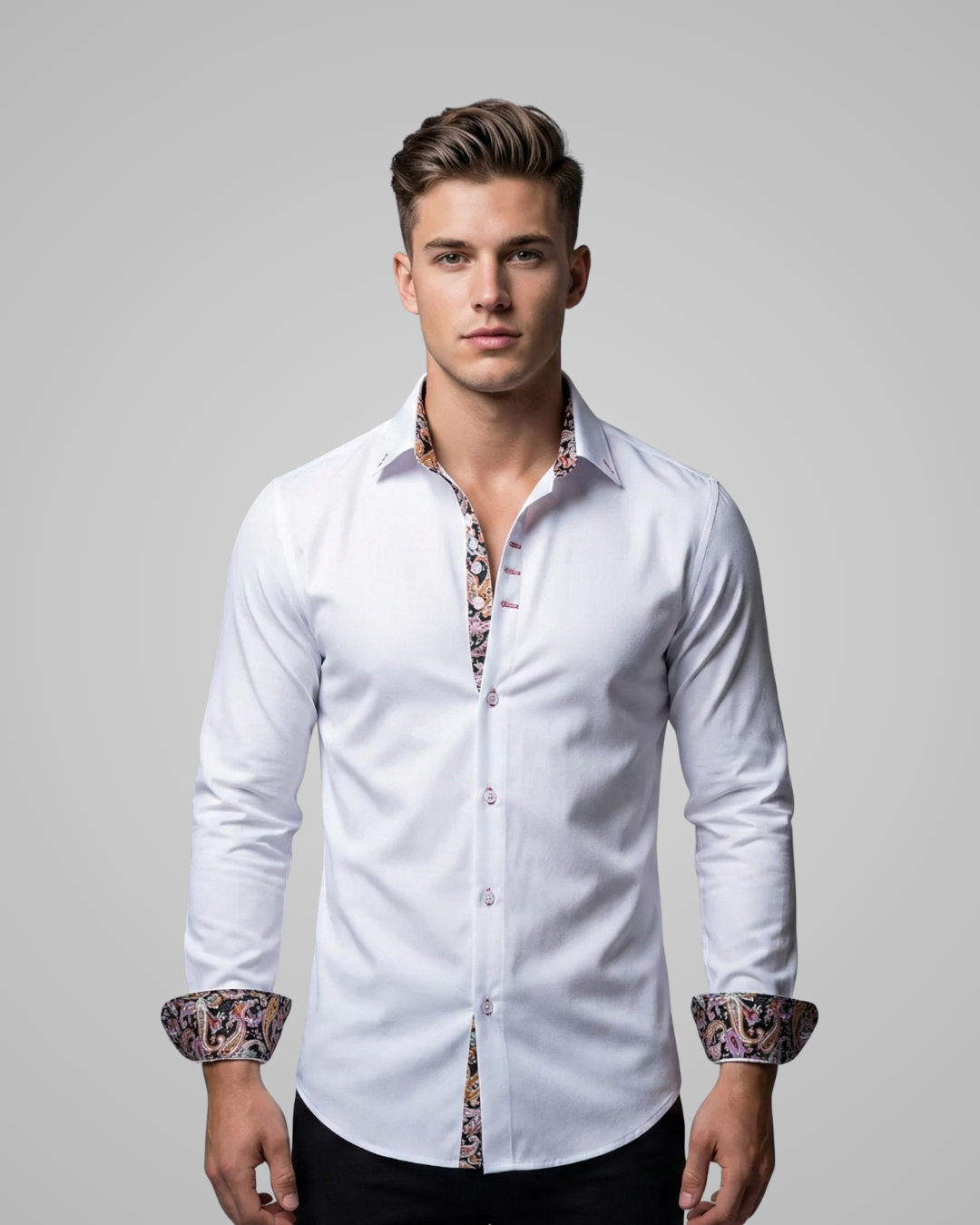 Man wearing a white dress shirt with patterned cuffs against a gray background