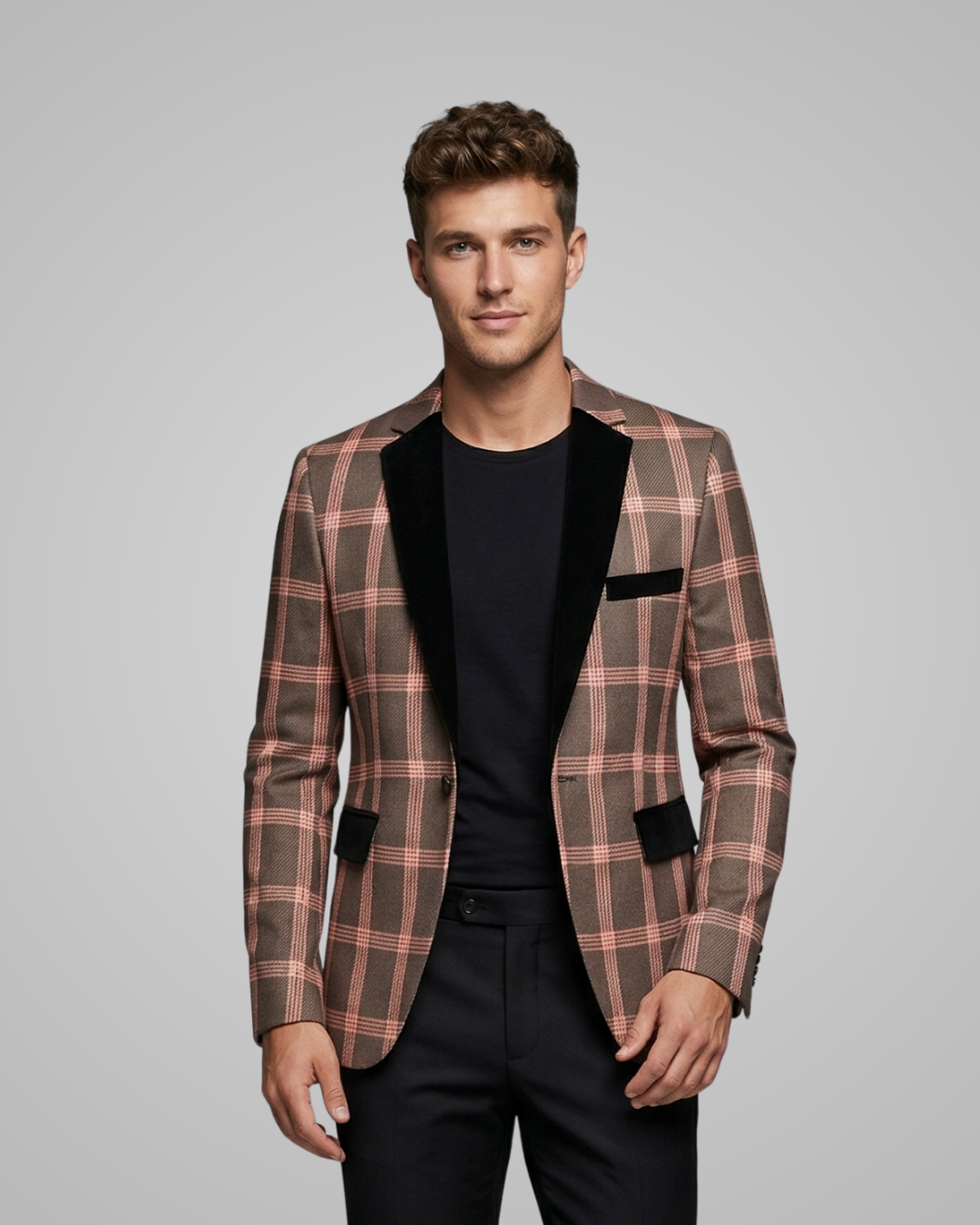 Man wearing a plaid blazer with black lapels on a gray background