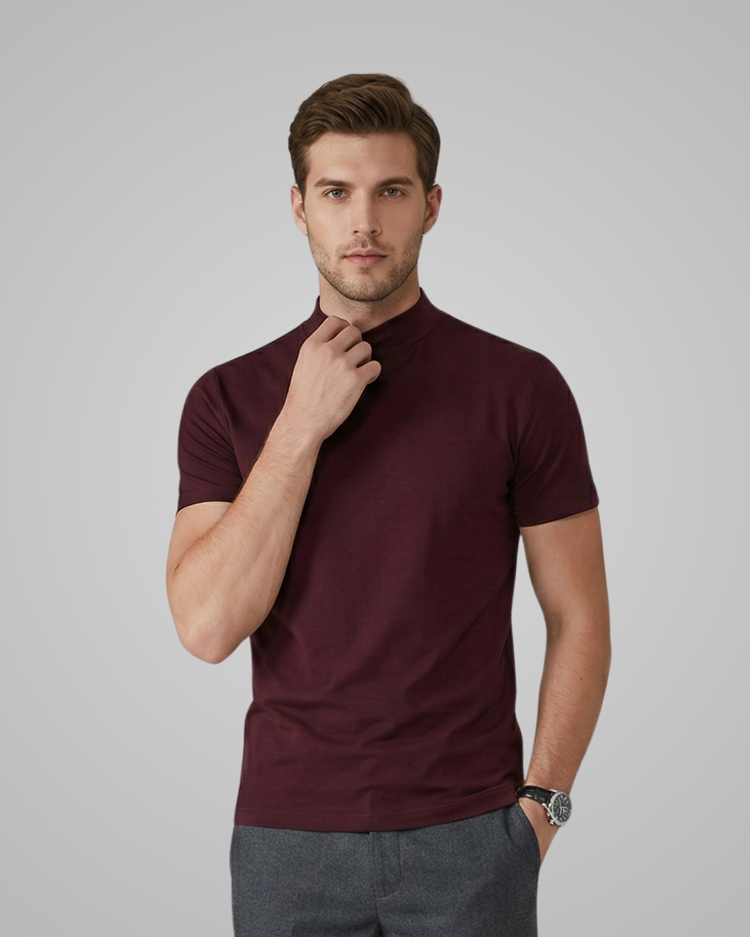 Man wearing a maroon polo shirt against a gray background