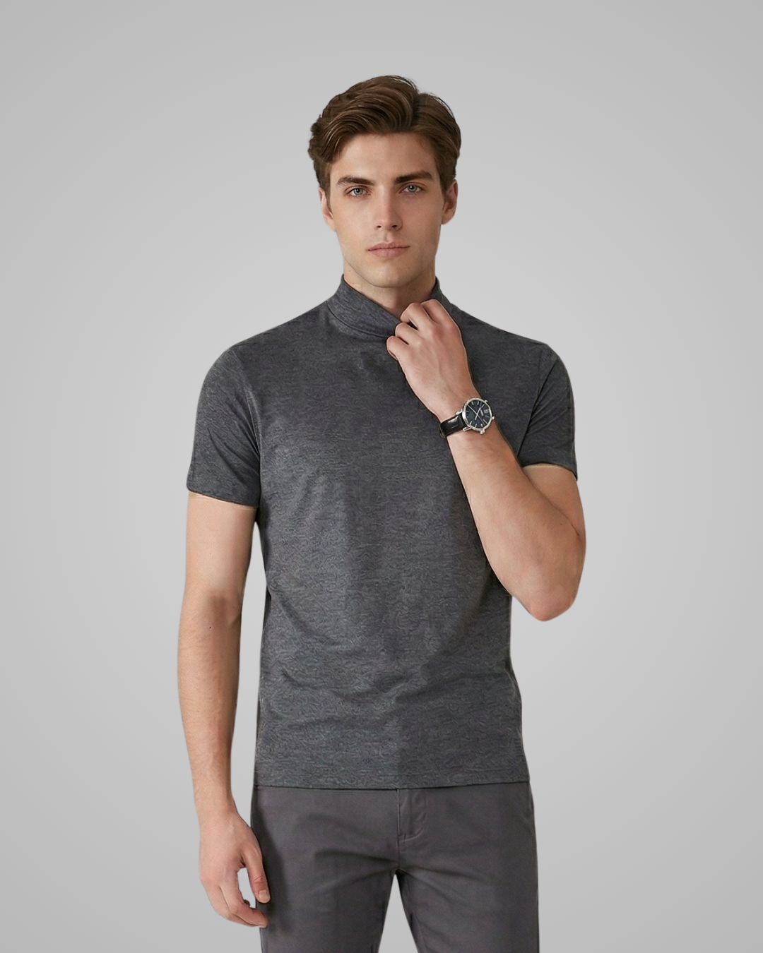 Man wearing a gray polo shirt and pants on a plain background