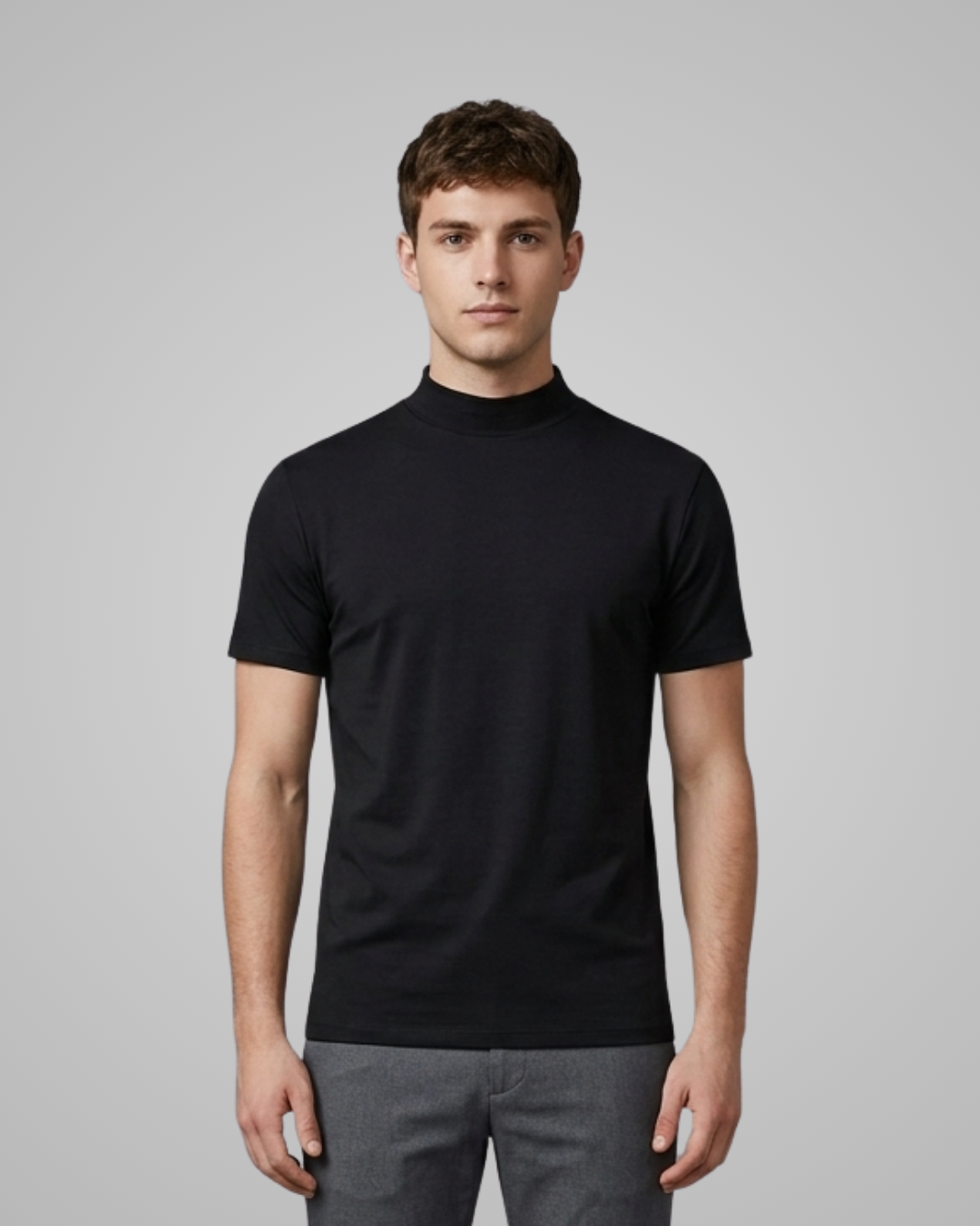 Man wearing a black turtleneck shirt against a gray background
