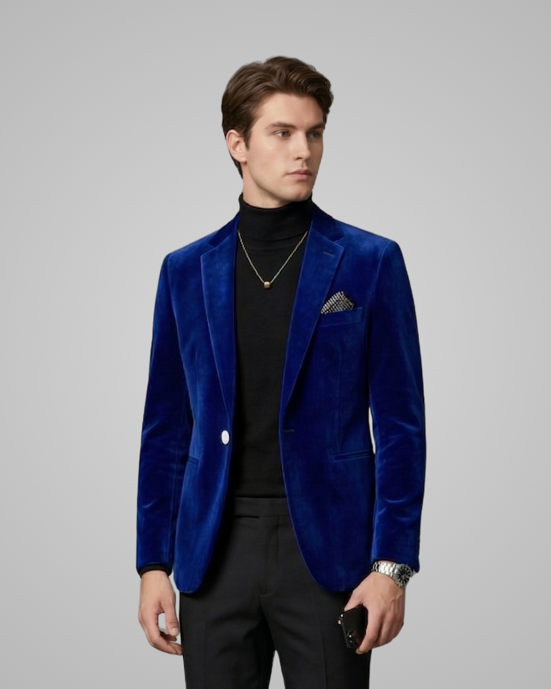 Man wearing a blue velvet blazer with a gray background