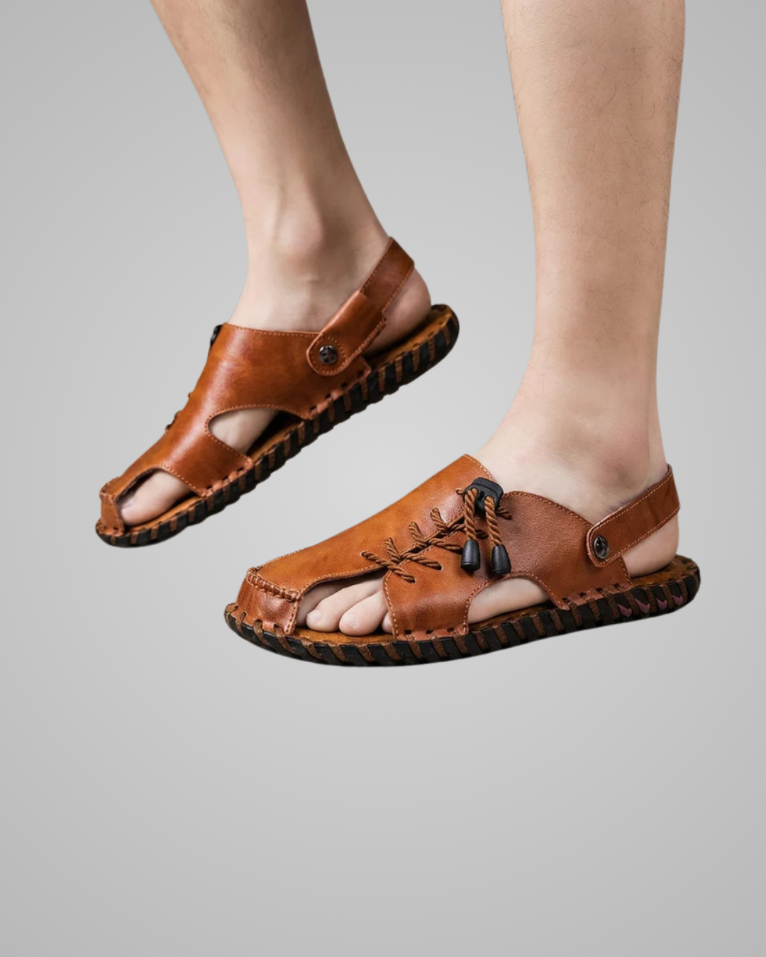 Brown sandals worn by a person on a gray background
