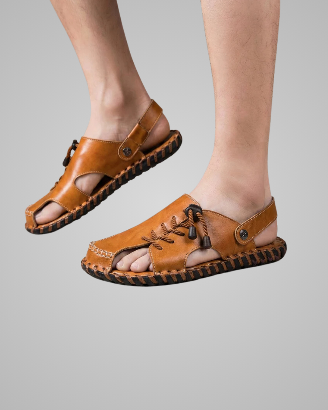 Brown sandals worn by a person on a gray background