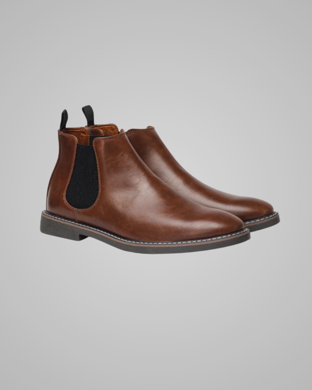 Pair of brown leather boots on a gray background