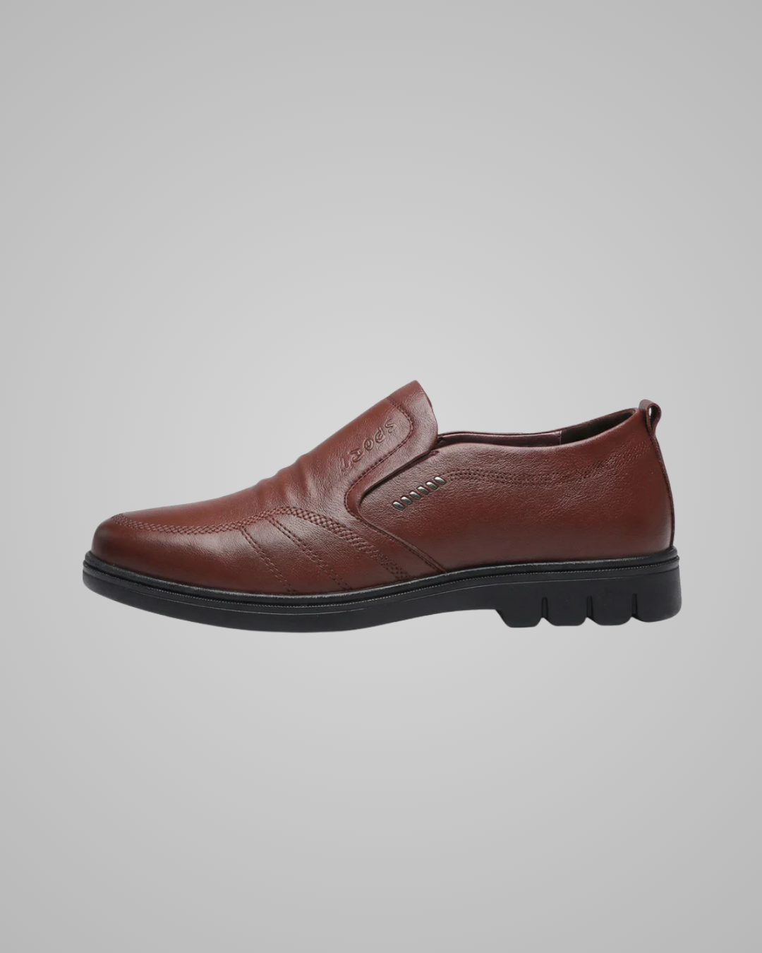 A brown leather slip-on loafer shoe with a black sole, shown in a side profile view against a solid gray background.