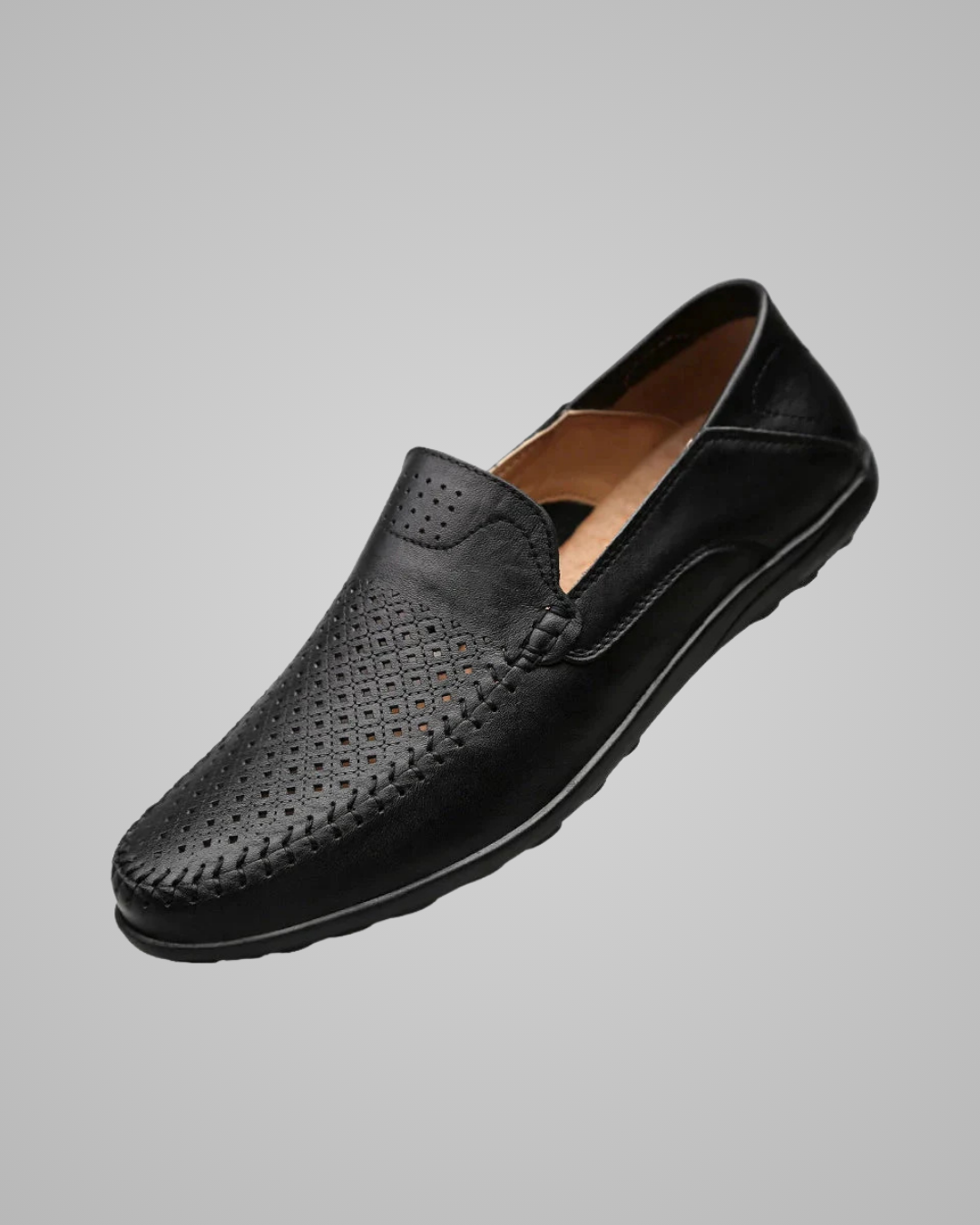 A single men's black leather slip-on loafer with perforated detailing on the toe and vamp, shown against a solid gray background.