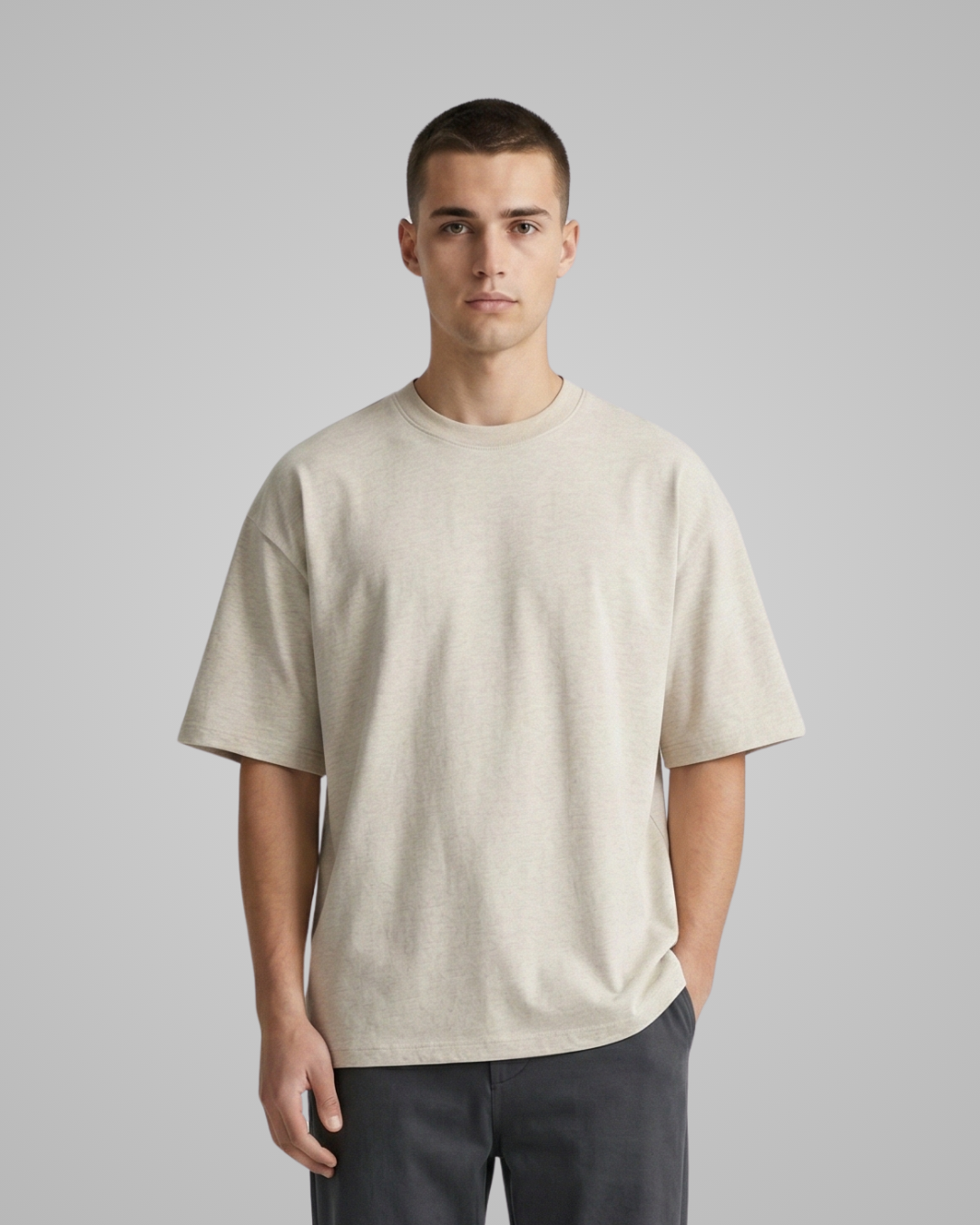 Man wearing a beige t-shirt against a plain background