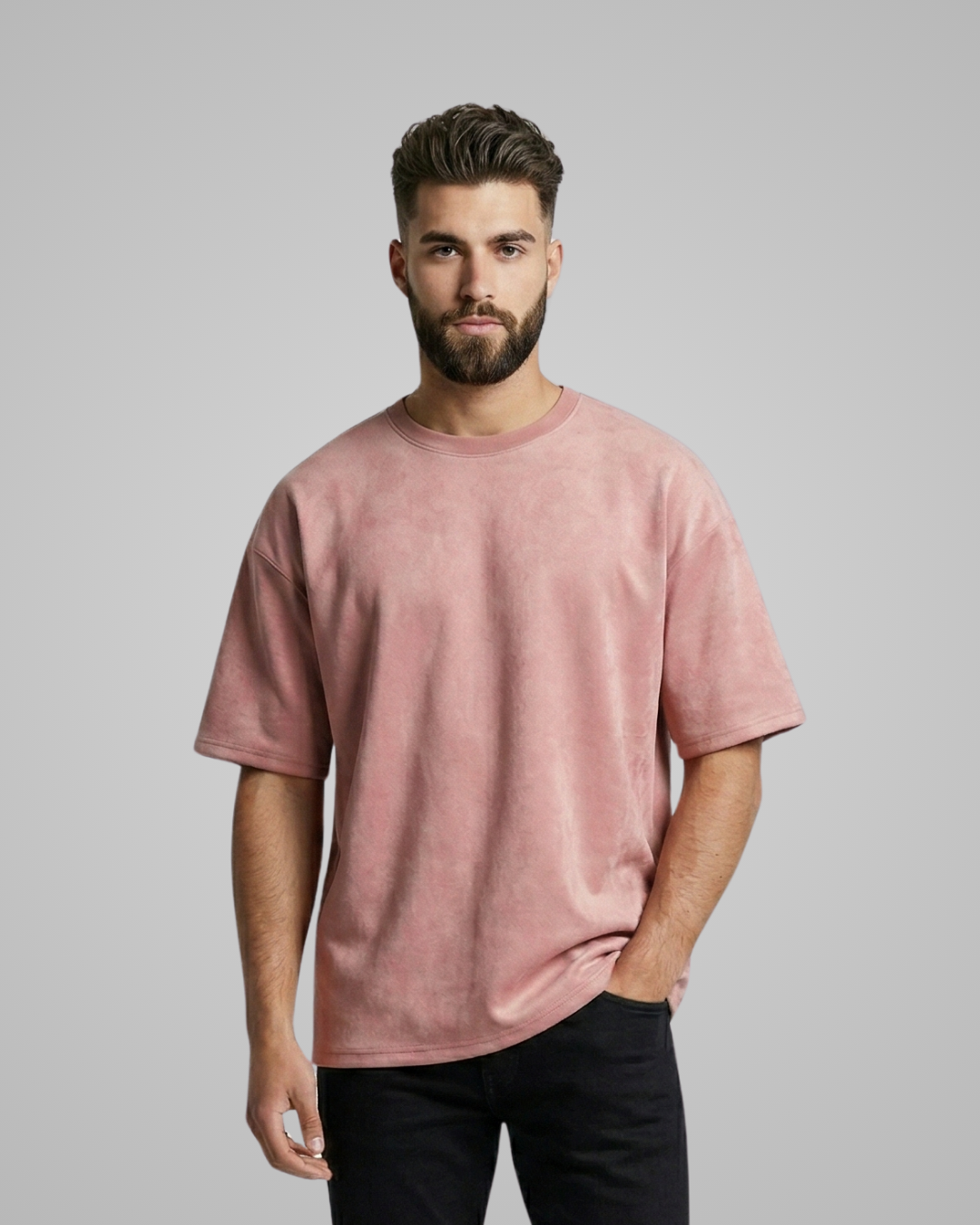 Man wearing a pink t-shirt against a gray background