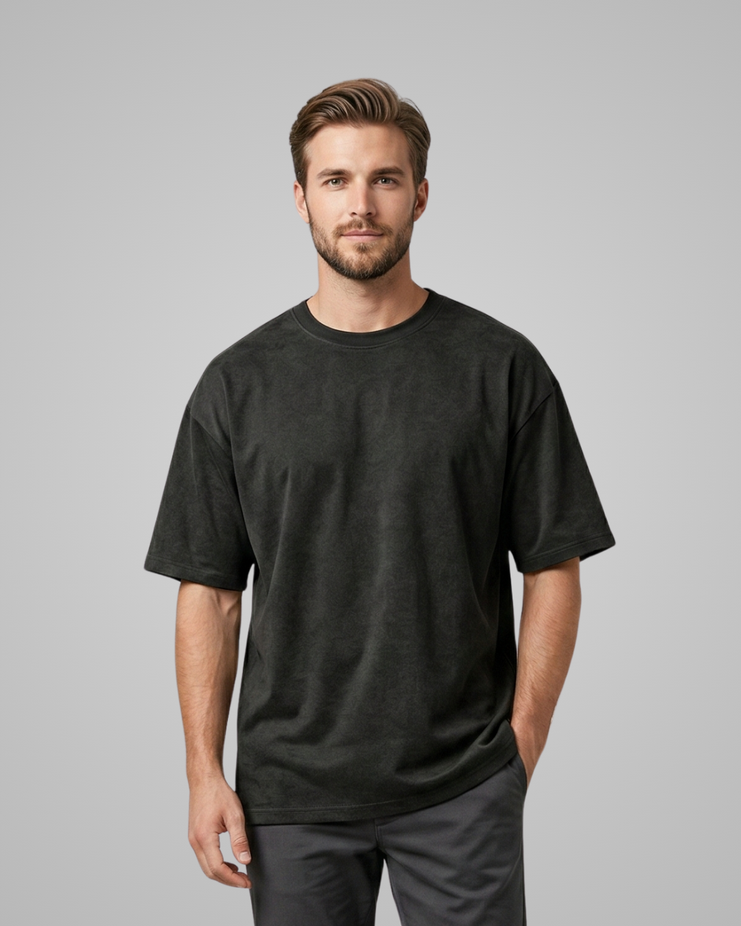 Man wearing a black t-shirt against a gray background