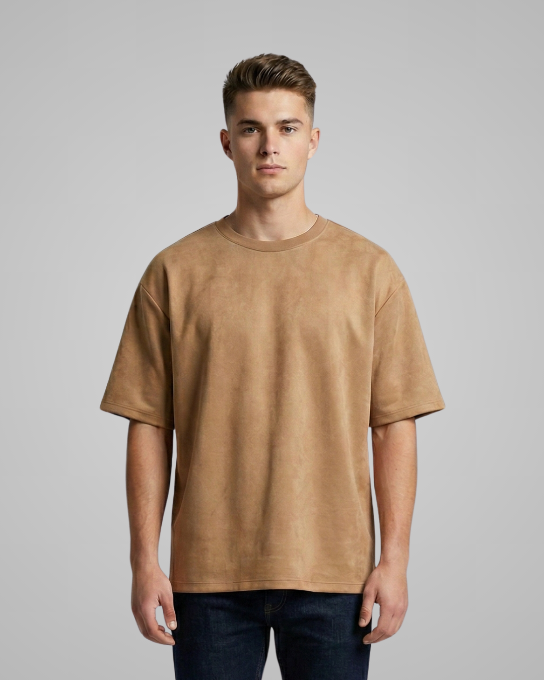 Man wearing a brown t-shirt against a gray background