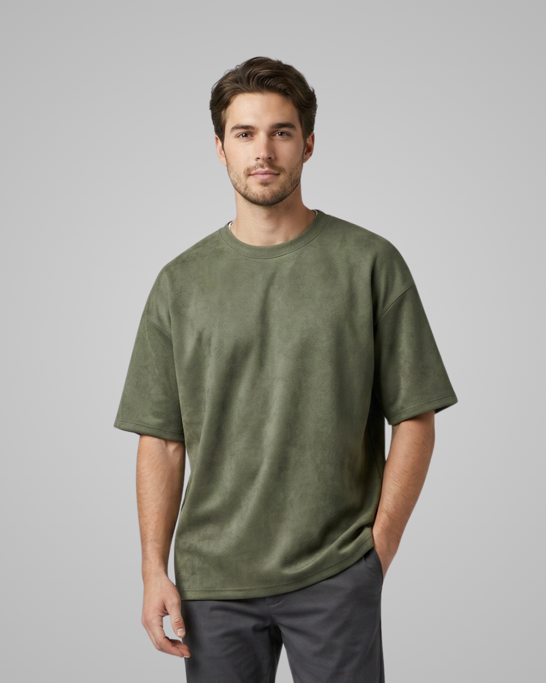 Man wearing a green t-shirt against a gray background