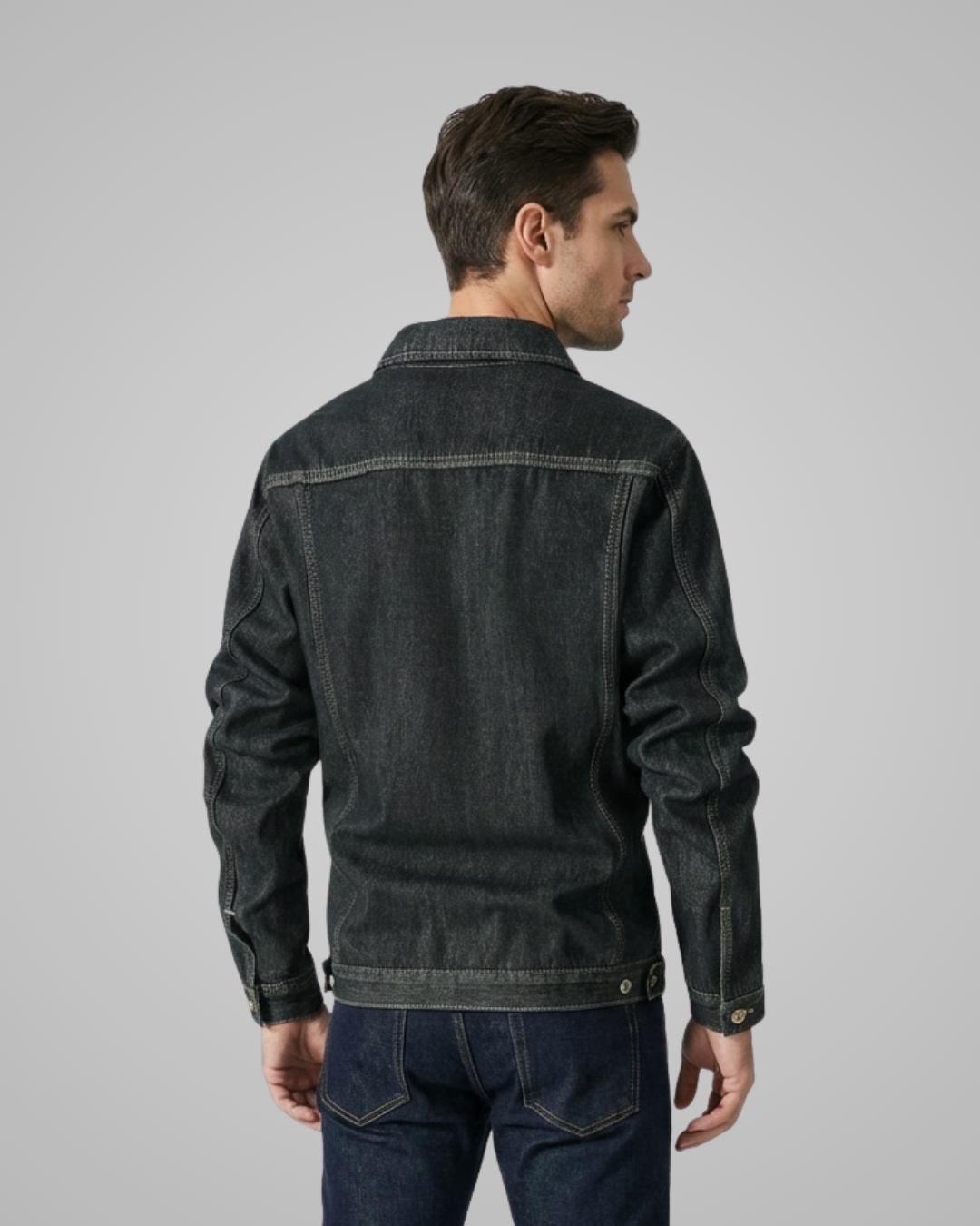 Man wearing a dark denim jacket on a gray background