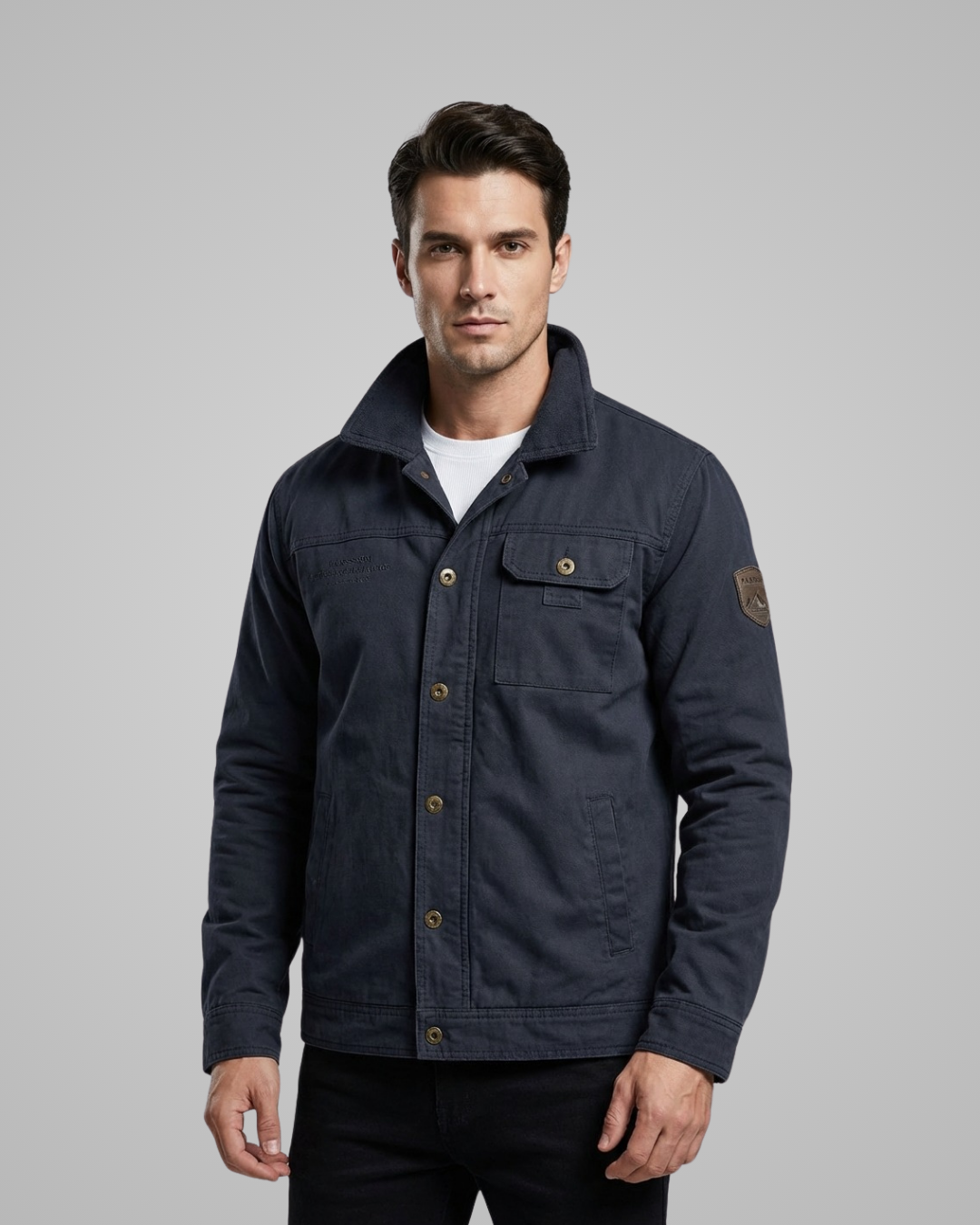Man wearing a navy blue jacket on a gray background