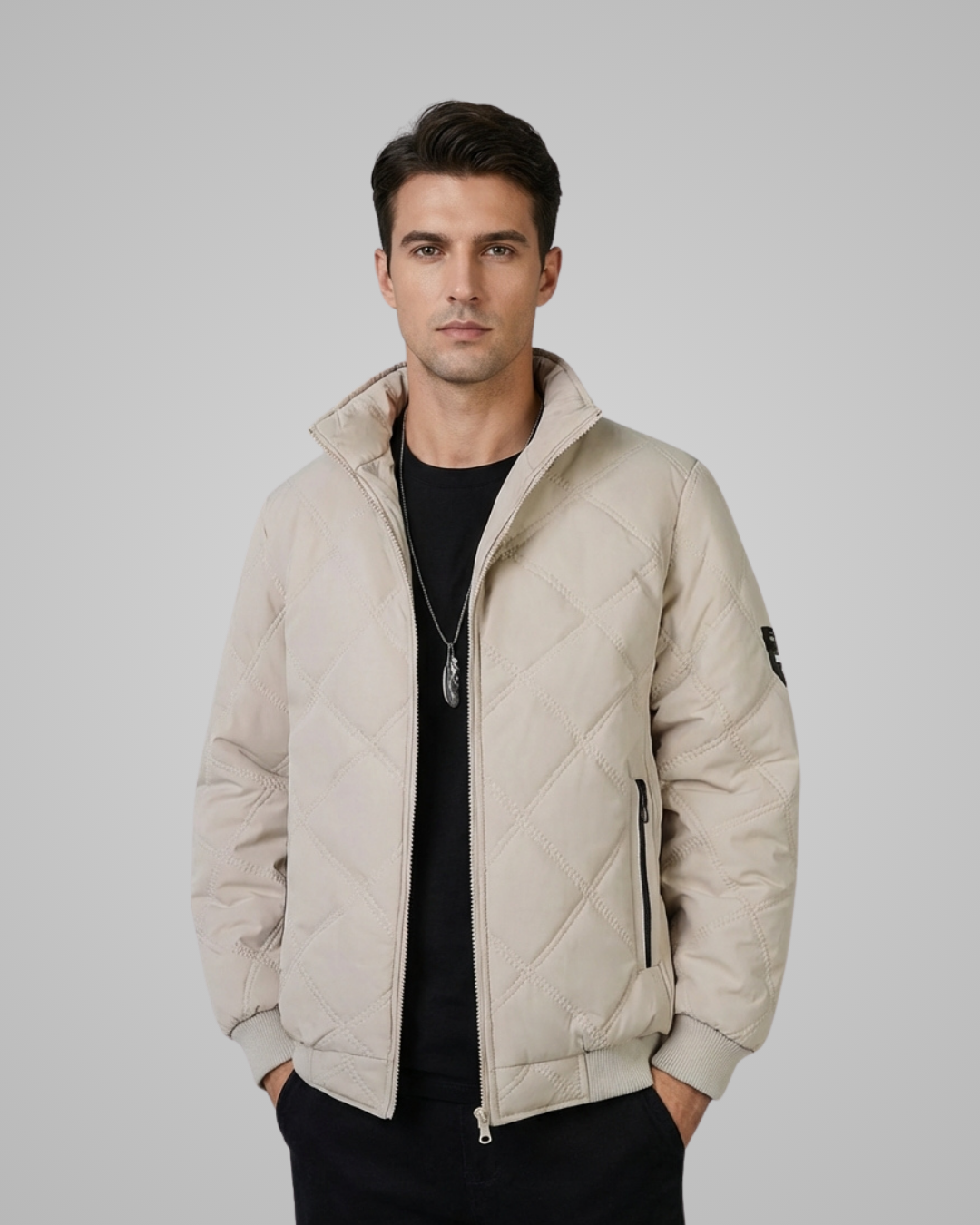 Man wearing a beige quilted jacket against a plain background