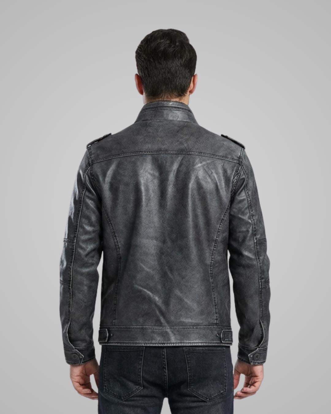 Man wearing a black leather jacket on a gray background