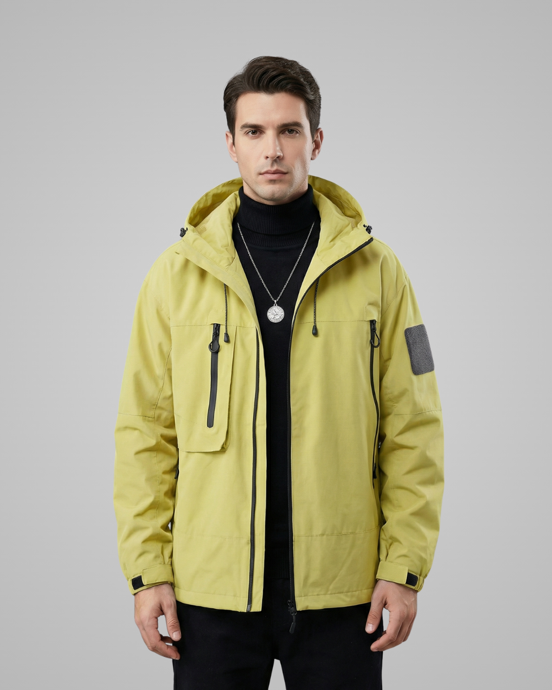 Man wearing a yellow jacket on a gray background