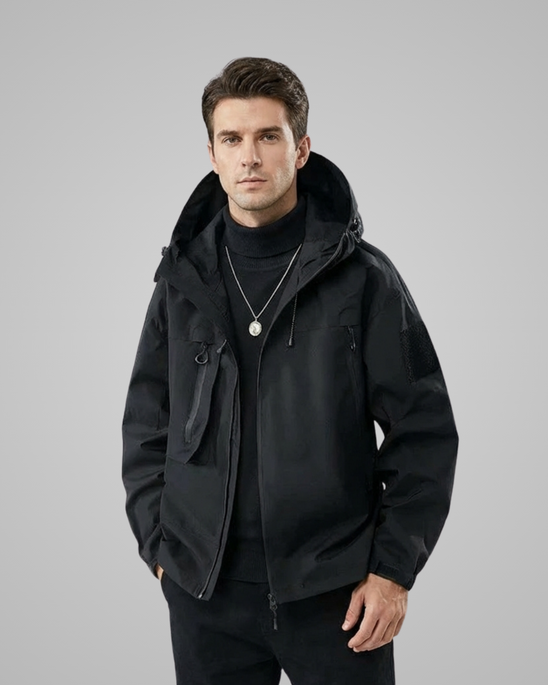 Man wearing a black jacket on a gray background