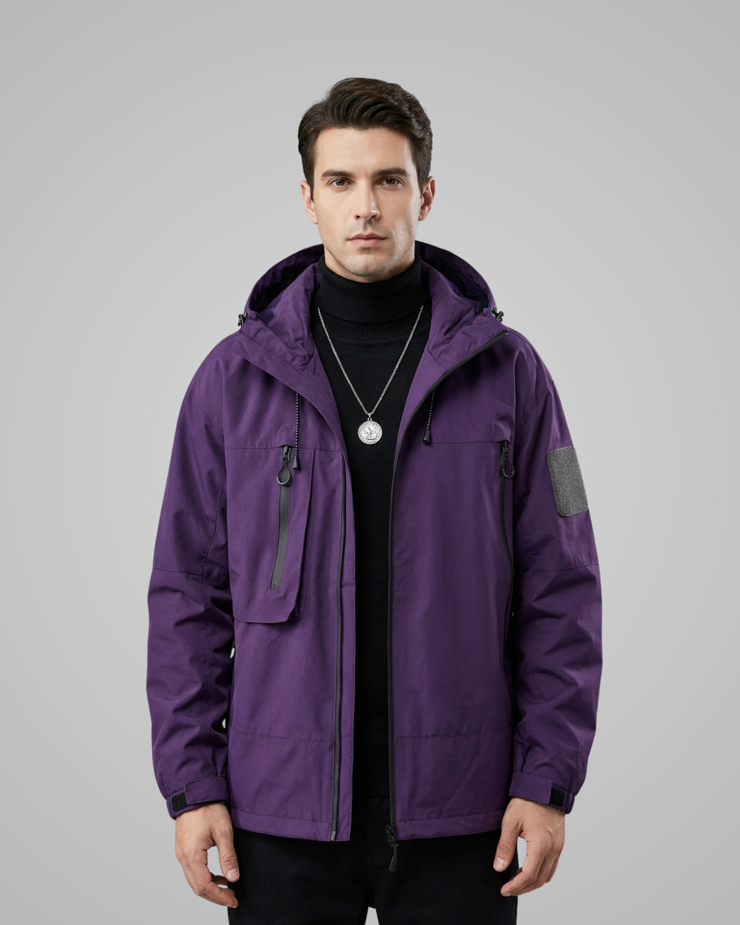 Man wearing a purple jacket on a gray background