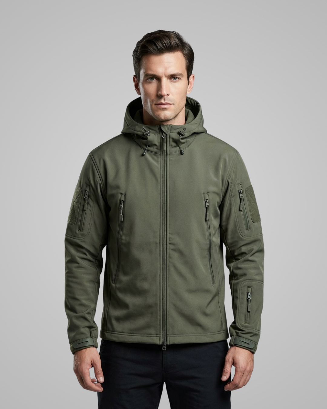 Man wearing a green tactical jacket on a gray background