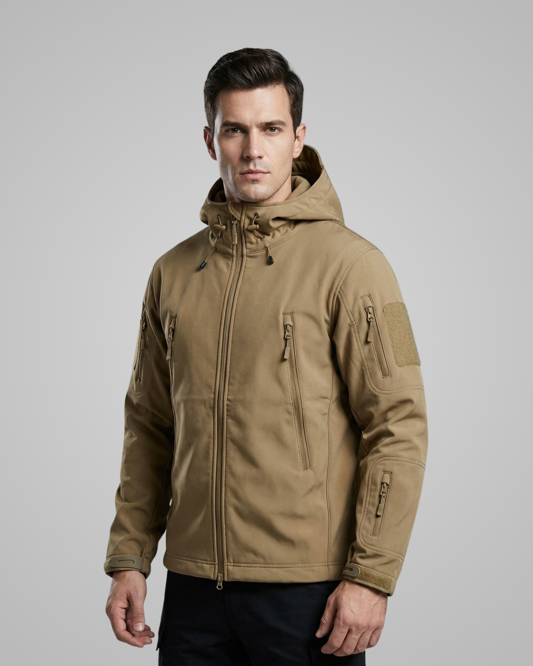 Man wearing a brown tactical jacket on a gray background